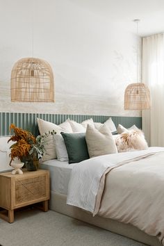 a bed with white sheets and pillows in a bedroom