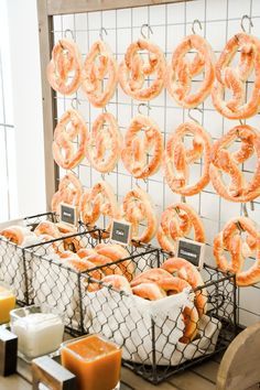 several baskets filled with donuts sitting on top of a table next to cheese and juice