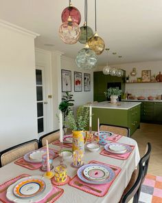 a dining room table with plates and place settings