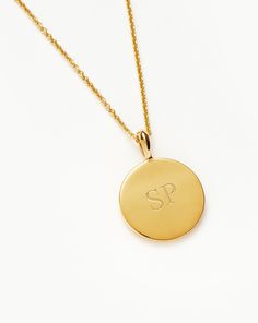 Engravable Round Necklace 18k Gold Vermeil. Make It Personal with a Necklace. Paired with a Delicate Chain, the Smooth Clip-On Pendant Can be Engraved on Both Sides – the Perfect Gift for that Special Someone. Opt for the Engravable Round Disc Pendant. Please Note: Engraving Items May Take 2 Working Days to Process. Metal: 18K Gold Plated Vermeil on Sterling Silver Pendant Dimensions: 15mm Chain Metal: 18K Gold Vermeil on Sterling Silver Short Plain Chain: Total Length 450mm with Extension Links at 410mm, 430mm and 450mm Weight: 4. 7 g Product Code: En-G-N1-Ns Malachite Necklace, Coin Pendant Necklace, Mixed Metal Jewelry, Earring Trends, Round Pendant Necklace, Pearl And Diamond Earrings, Round Necklace, Solid Gold Earrings, Disc Pendant