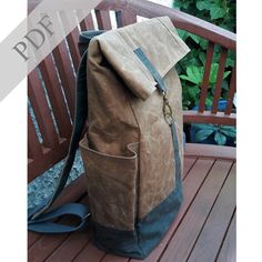 a brown and blue backpack sitting on top of a wooden bench