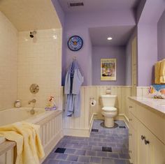 a bathroom with purple walls and blue flooring