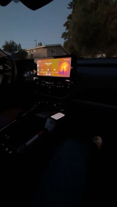 the dashboard of a car with an image on it's screen in the dark