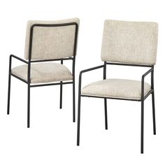 a pair of chairs with beige upholstered fabric and black metal frame, on white background