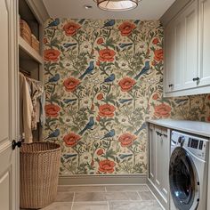 a washer and dryer in a laundry room with wallpapered flowers on the walls