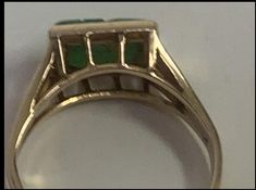 The jade is carved with a flower and is a bright emerald green with a stem and scroll., beautifully displayed in a raised gold cage, and bezel set in 14k yellow gold women's jewelry. Although antique, this jade ring has a contemporary look that complements today's tastes. Specifications: Metal: 14K Yellow Gold Style: Statement Ring Ring Size: 4 Gemstone Specifications: Center Gemstone: Jade Shape: RectangularColor: GreenCut: Cabochon Boxed - Only One Available Free shipping via USPS in 2 - 7 Day Art Deco Green Emerald Ring In 14k Gold, Art Deco 14k Gold Emerald Ring, Victorian Green Jewelry Stamped 14k, Art Deco Emerald Ring In 14k Gold, Antique Emerald Ring In Stamped 14k Yellow Gold, Art Deco Round Green Emerald Ring, Classic Green Emerald Ring For Collectors, Antique Green Emerald Cut Ring, Antique Green Emerald-cut Emerald Ring