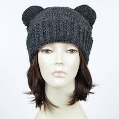 a mannequin head wearing a knitted hat with bear ears on it's side