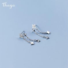 Elevate your style with Thaya's 925 Silver Star Chain Necklace for women. Made from high-quality silver, this necklace features a stunning star pattern that is both elegant and chic. The durable chain material of 925 silver ensures longevity and can be worn for any occasion. Designed with female gender in mind, it adds a touch of sophistication to any outfit. With a unique star pattern, it is sure to turn heads. Add some beauty to your collection with Thaya's stunning 925 Silver Star Chain Neckl Star Chain, Star Pattern, Silver Stars, Star Patterns, Tassel Earrings, Necklace For Women, Chic Design, Womens Necklaces, 925 Silver