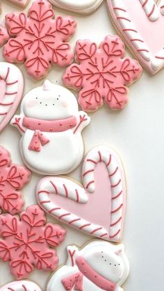 decorated cookies with pink and white frosting on a table