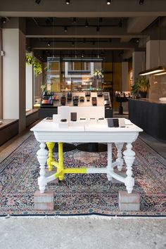 a white table sitting on top of a rug