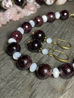 Necklace Length: 45.5+7cm (18+2.75in)*Weight: 133g Bracelet Length: 18.5+4cm (7.25+1.5in)* Weight: 26g Earrings Length: 33mm Weight: 6g Necklace “Wild Roses” - Porcelain Beads, Garnet, Pink Agate Raw Faceted Beads (biggest 26x26mm), Mother of Pearl, Brass Accessories.Pink Agate- a symbol of good luck. It is believed that the longer you wear pink agate, the better it works.Garnet- the stone with the most powerful energy. Helps to achieve goals and not lose enthusiasm. Needed by every traveler, bu Anniversary Jewelry With Matching Round Bead Earrings, Formal Hand-strung Jewelry, Spiritual Single Strand Round Jewelry, Spiritual Jewelry With Round Beads And Matching Earrings, Spiritual Single Strand Jewelry, Classic Gemstone Beads Jewelry For Jewelry Making, Classic Jewelry With Gemstone Beads For Jewelry Making, Round Beads Jewelry With Natural Stones For Anniversary, Classic Natural Stones For Jewelry Making