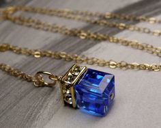 Give a stunning royal blue necklace to a woman who loves modern and elegant jewelry.  This minimalist design delivers maximum oomph in a spectacular popular blue hue. She can dress up anything with this bright sapphire blue necklace. Perfect gift for women born in September since sapphire is one of her birthstone.Swarovski crystal cube pendants come in all birthstone colors and neutrals. Give an elegant yet personal gift to all the women in your life. Adjustable necklace for the perfect fit ever Cube Pendant, Blue Crystal Necklace, Bridal Party Jewelry, Cube Necklace, Blue Crystal Earrings, Handmade Fine Jewelry, Bridesmaid Wedding, Bridesmaid Necklace, September Birthstone