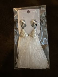 These are a beautiful pair of brand new tassel earrings. These are CLIP-ON EARRINGS. The size is 3” x 1.5” wide. Ships immediately to US addresses only. Elegant Formal Chandelier Earrings With Latkans, Silver Dangle Earrings With Tassels, Formal Dangle Tassel Earrings, Elegant Dangle Chandelier Earrings With Latkans, Chic Formal Jewelry With Tassels, Elegant White Decorative Jewelry, Tassel Drop Earrings For Evening, Elegant Fringe Earrings, Elegant Plug Earrings With Latkans For Party