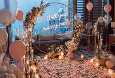 a room decorated with balloons, flowers and candles for a wedding ceremony in the city