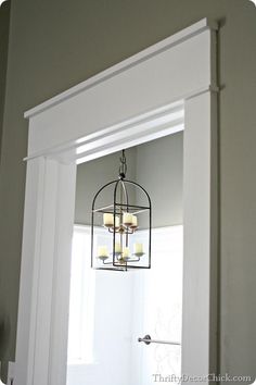 an open door with a light fixture hanging from it