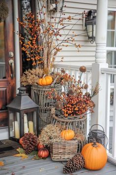 fall decorations on the front porch with pumpkins and gourds in wicker baskets