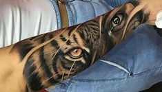 a man with a tiger tattoo on his arm