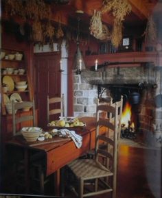 an old fashioned dining room with a fireplace