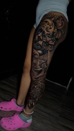 a woman's leg with tattoos and pink shoes