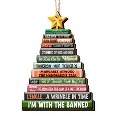 a christmas tree made out of books with a star hanging from it's top