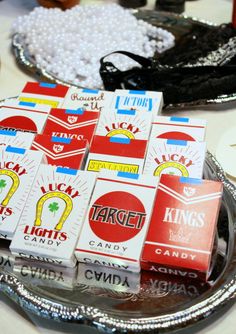 several boxes of candy sitting on top of a silver tray