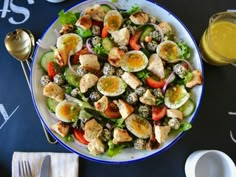 a salad with hard boiled eggs, tomatoes and cucumbers in it on a white plate