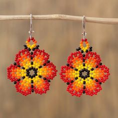 This impressive pair of dangle earrings from Mexico features the image of two flowers that blaze with hues of red orange and yellow. Using the skills that she learned from her parents and grandparents Adriana Trejo handcrafts this accessory diligently applying petite glass beads by hand. Each earring dangles from a hook of sterling silver. Seed Beading, Colorful Jewelry, Just Because Gifts, Glass Flowers, Beaded Dangle Earrings, Beading Tutorials, Glass Bead Necklace, Beaded Dangles, Bead Art