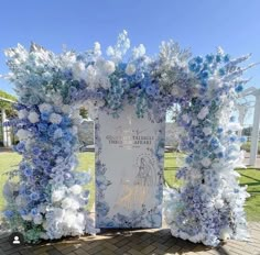 a blue and white wedding arch decorated with flowers