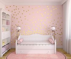 a pink and gold girls'room with polka dot wall decals on the walls