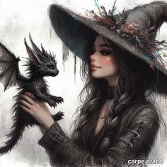 a woman in a witches hat holding a small black dragon on her right hand and wearing a feathered witch's hat