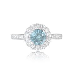 a blue and white diamond ring with diamonds around it's center stone, set in 18k white gold