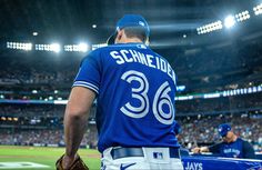 a baseball player standing in the outfield at a game