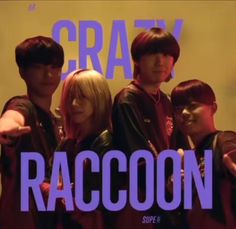 a group of people standing next to each other in front of a sign that says crazy raccoon