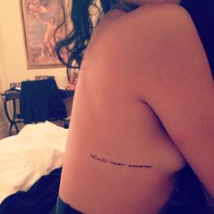 the back of a woman's body with writing on it