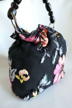 "Authentic Christian Dior Very Rare Velvet Bucket Black & Floral Satin Baguette Made in France Vintage Condition - Excellent Vintage Condition Please check our store Very Rare Piece of Art Size & Product Information: 1. 100% Authentic Christian Dior 2. Crafted in France / Made in France 3. Silver tone hardware 4. Black satin mini bucket bag with multi color velvet floral pattern 5. Elastic opening with gathered top 6. Signed \"Christian Dior PARIS\" \"MADE IN IN FRANCE\" inside 7. Beaded Elegant Square Pouch With Dust Bag, Designer Evening Pouch With Top Carry Handle, Designer Black Square Clutch, Luxury Square Bucket Bag For Evening, Elegant Black Top Handle Pouch, Designer Black Square Bucket Bag, Formal Multicolor Shoulder Bag With Dust Bag, Elegant Handmade Black Bag, Designer Pouch Evening Bag With Handles