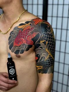 a man with a tattoo on his chest holding a bottle of ink in front of him