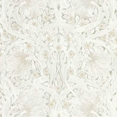 an ornate white wallpaper with flowers and leaves on the side, as well as a pattern