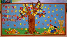 a child's birthday bulletin board with an apple tree and fall leaves on it