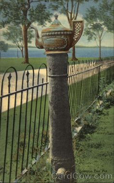 a painting of a teapot on top of a pole in front of a fence