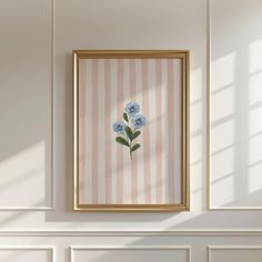 a painting hanging on the wall next to a white fireplace with blue flowers in it