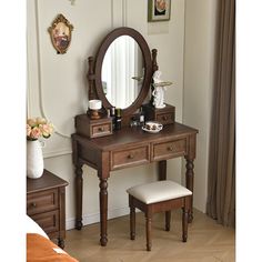 a dressing table with a mirror and stool