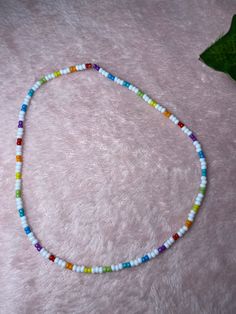 White and Rainbow Seed Bead Necklace Trendy White Necklace With Letter Beads, Trendy White Jewelry With Large Beads, Trendy White Beaded Chain Necklace, Trendy White Beaded Necklace, Casual White Beaded Necklaces, Casual White Beaded Necklaces With Tiny Beads, Casual White Necklace With Letter Beads, Casual White Necklaces With Letter Beads, Casual White Beaded Bracelets