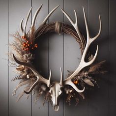 a deer skull wreath with antlers and berries