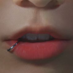 a woman's lips with a pair of scissors in her mouth