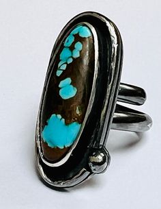 sterling silver handmade turquoise statement ring.  * This  stunning number 8 turquoise marquise cabochon measures 30x13mm all settings are handmade from sterling silver wire. the band is made from sterling silver d-shaped wire which is 4x2.5mm. the setting around the cabochon is also d-shaped wire. this piece was oxidised to darken the silver, * All my pieces are hallmarked at the Edinburgh assay office with traditional and my sponsor mark. * Comes gifted boxed * Hallmarked at Edinburgh assay office * Uk size S 1/2 US size 9 3/8 Handmade Unique Turquoise Ring In Sterling Silver, Unique Handmade Turquoise Sterling Silver Ring, Handmade Unique Turquoise Sterling Silver Ring, Unique Oval Turquoise Ring With Patina, Handmade Adjustable Oval Turquoise Ring, Handmade Artisan Turquoise Ring With Oval Cabochon, Adjustable Sterling Silver Turquoise Ring With Oval Cabochon, Unique Silver Turquoise Ring With Oval Cabochon, Unique Silver Turquoise Ring With Cabochon