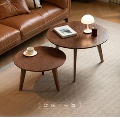 two wooden tables sitting on top of a carpeted floor next to a brown couch