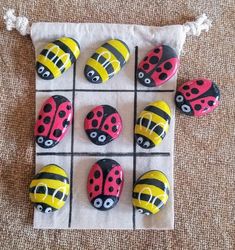 six ladybug magnets sitting on top of a cloth bag