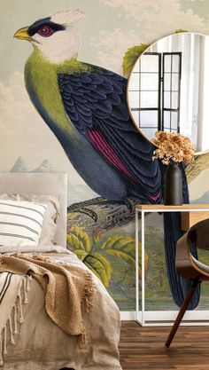 there is a bird painted on the wall next to a bed and table with a mirror