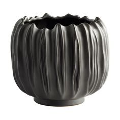 a black vase with wavy lines on the outside and inside, in front of a white background