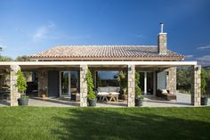 an outdoor patio with stone pillars and potted plants